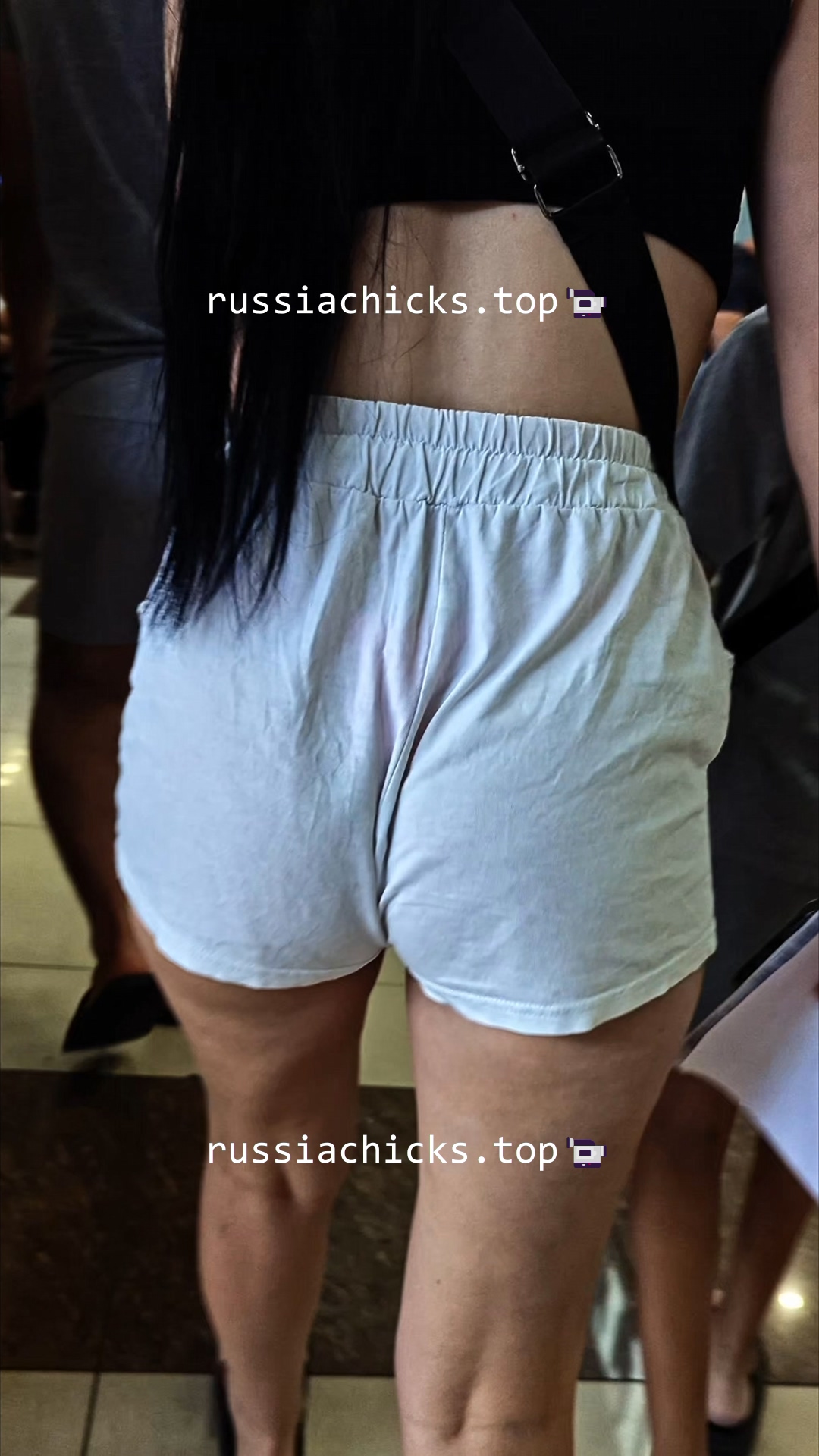 chick in shorts in shopping mall