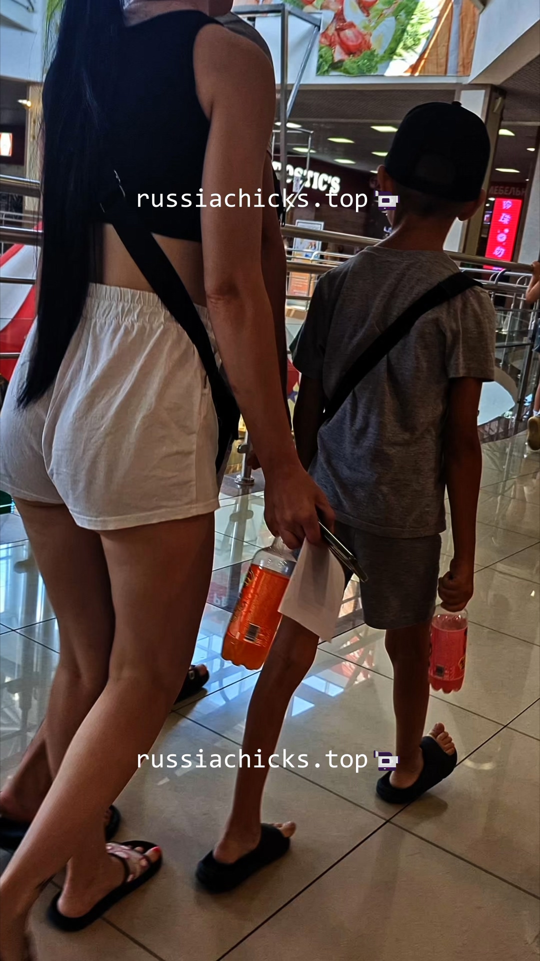 chick in shorts in shopping mall